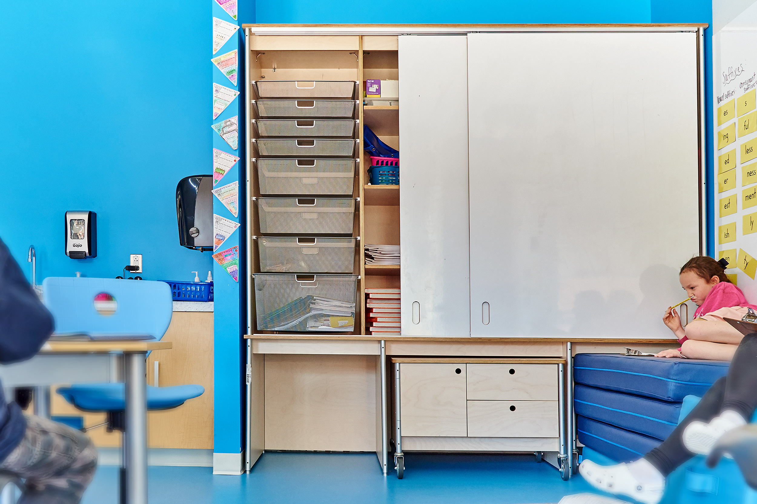 classroom wall storage with whiteboard baskets and cubbies